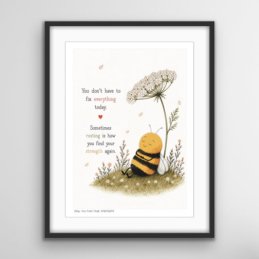 A framed fine art print featuring a peaceful illustrated bee resting beneath wildflowers with the words, “You don’t have to fix everything today. Sometimes resting is how you find your strength again.”