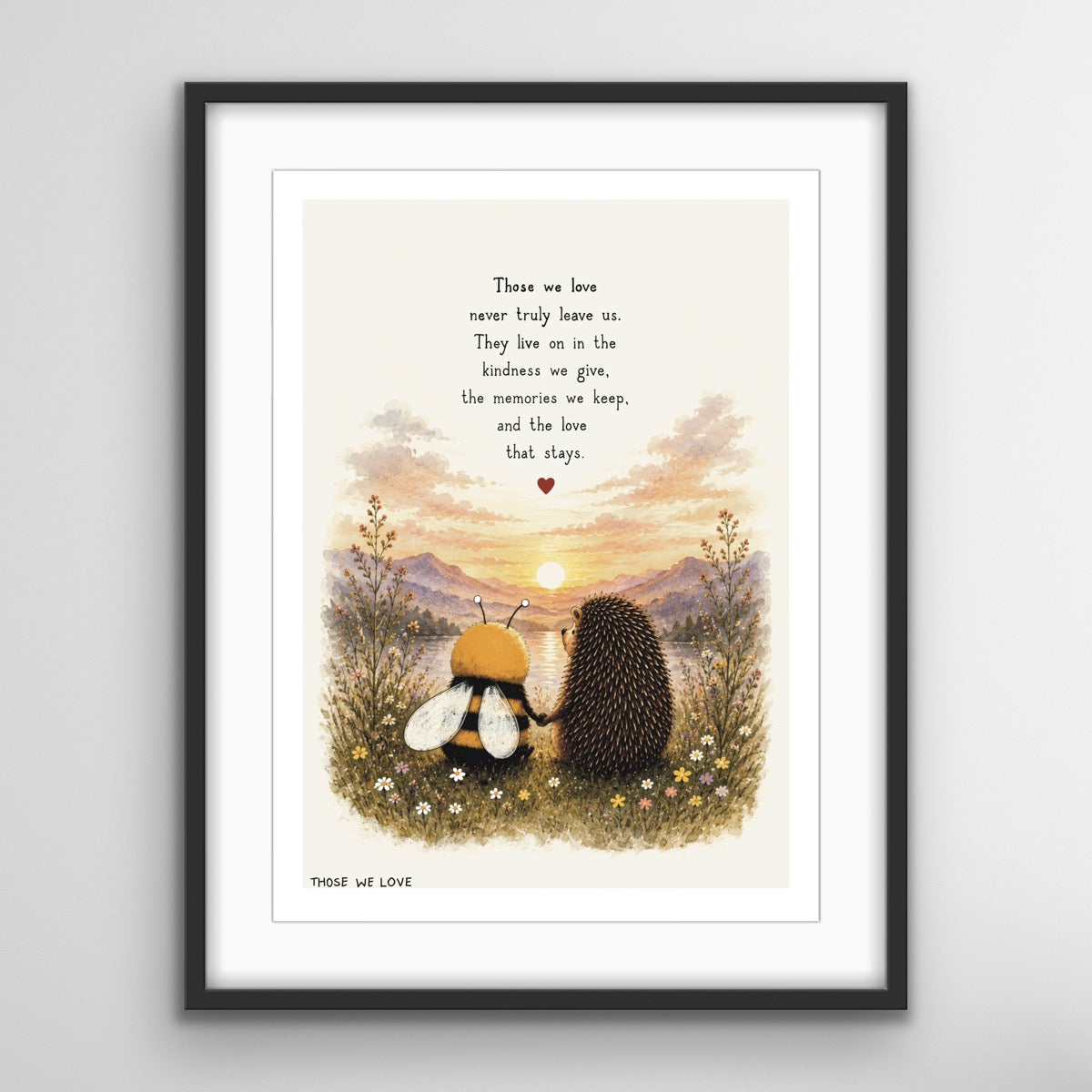 A remembrance art print featuring a bee and hedgehog sitting together among wildflowers, watching a sunset over the mountains, with the words “Those we love never truly leave us”.